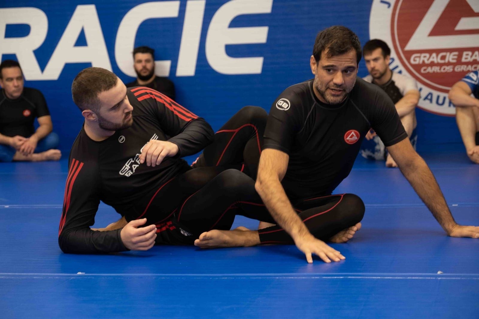 Adults practicing Brazilian Jiu-Jitsu techniques in Montreal training class